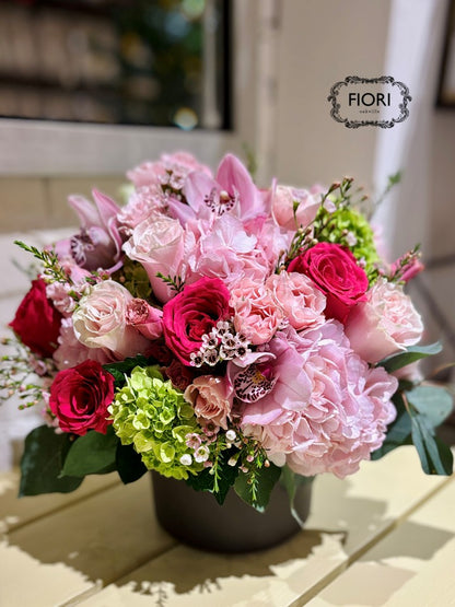 Oakville Flower shop. Luxury Mother's Day flower arrangement "Dolce Mamma" featuring hot pink roses, Cymbidium orchids, and green hydrangea in a chocolate ceramic vase. Oakville online Delivery. 